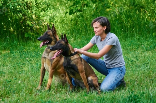 Preview: The woman is holding her dogs.