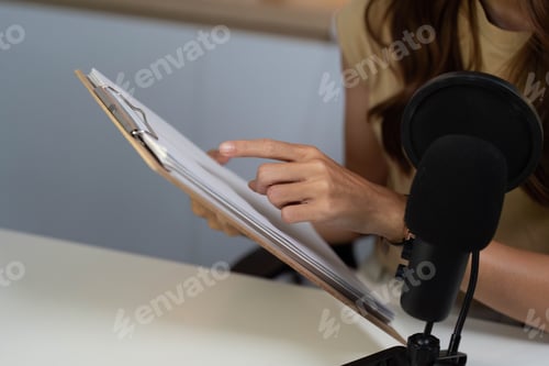 Preview: Document Review in Digital Communication. Woman pointing at a clipboard during a virtual session.