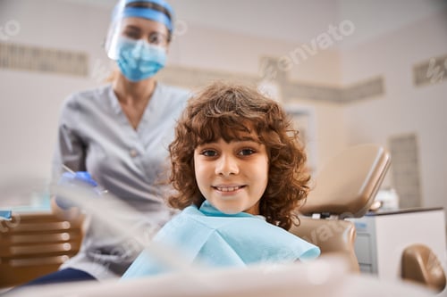 Preview: Young patient looking happy at dentist office
