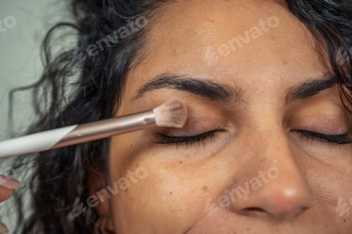 Preview: Close-up of a woman applying eyeshadow, highlighting her beauty routine