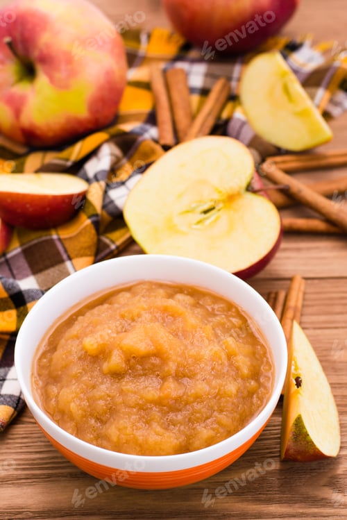 Preview: Apple puree, apples and cinnamon on a wooden table
