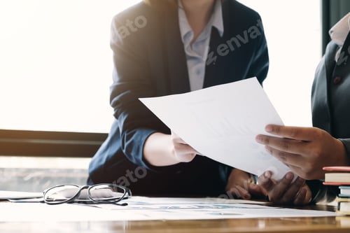 Preview: Business team analyzing income charts and graphs with modern laptop computer. Close up.Business