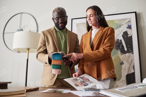 Preview: Two young creative designers choosing color and textile from sample collection