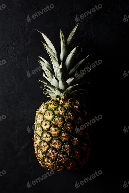 Preview: Ripe pineapple on a black background