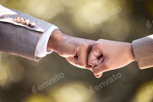 Preview: Cropped shot of two unrecognisable businesspeople giving each other a fist bump in the city
