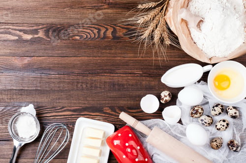 Preview: Ingredients for baking. Flour in paper bag, eggs, butter, kitchen utensils on wooden background