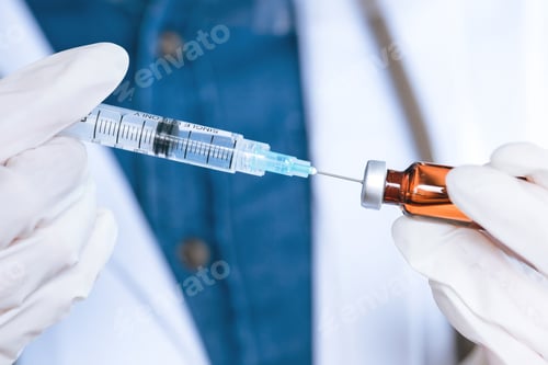 Preview: Hand with medical gloves filling the syringe with vaccine from bottl