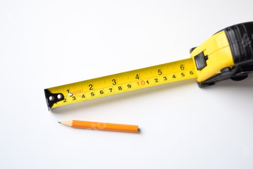 Preview: Minimal shot of yellow tape measure and a pencil on white background