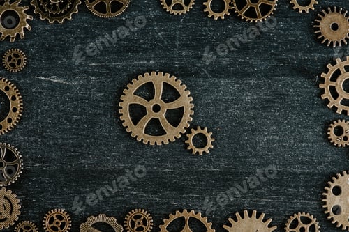 Preview: top view of vintage metal gears in frame on dark wooden background