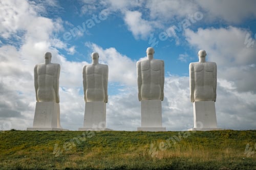 Preview: White Men statues, Esbjerg, Denmark. Four white men sitting looking at the sea near Esbjerg