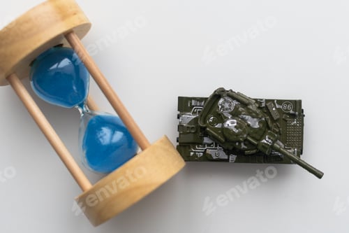 Preview: The plastic tank toys on the floor next to an hourglass