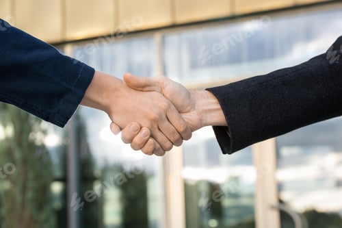 Preview: Handshake of successful business partners against exterior of modern building