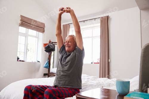 Preview: Senior Man Waking Up And Stretching In Bedroom