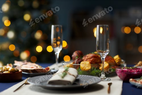 Preview: Christmas Table Setting with Empty Champagne Flutes for Festive Dinner