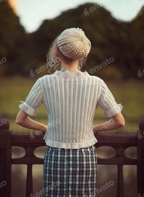 Preview: Woman standing back to vintage clothes and beret