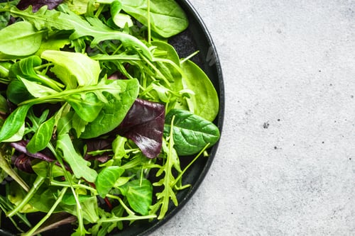 Preview: Salad from green leaves and vegetables on white.