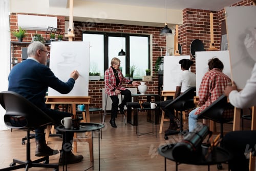 Preview: Senior teacher explaining drawing technique to multi-ethnic art students