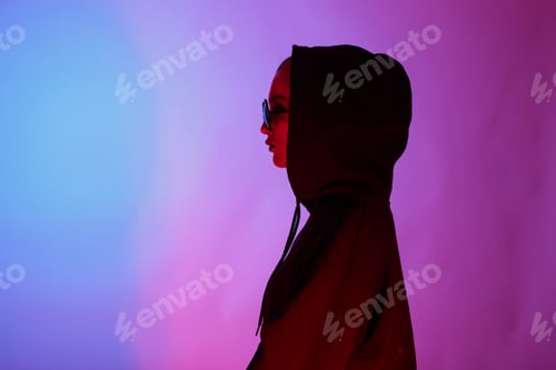 Preview: Portrait of fashion young girl in a black sweater with a hood and round sunglasses in red and blue