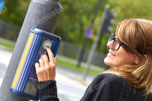 Preview: Young Caucasian Woman Pressing Pedestrian Button On The Traffic Light Pole.