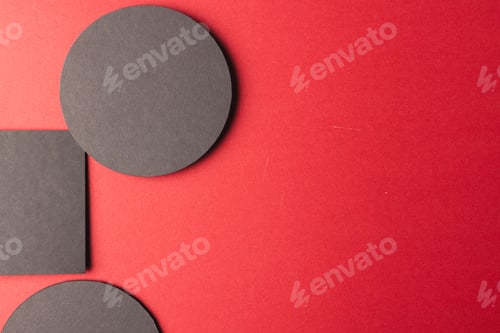 Preview: Square and circles of black paper with copy space on red background