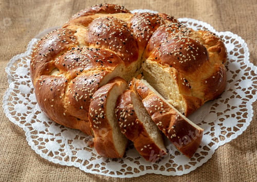 Preview: Easter bread, round shape greek tsoureki braid cut slices, above view