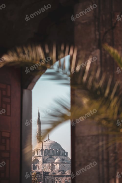 Preview: View on a mosque through an open wooden door