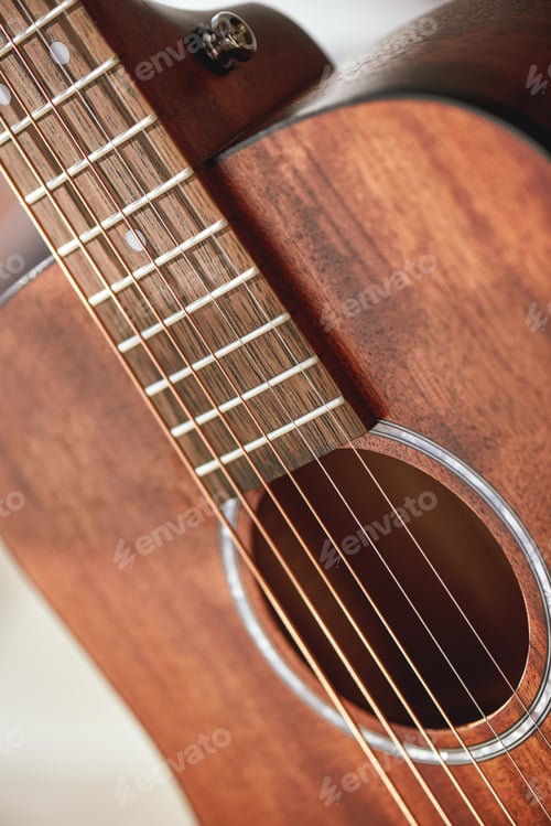 Preview: Guitar Anatomy. Close up photo of acoustic guitar sound hole with metal strings