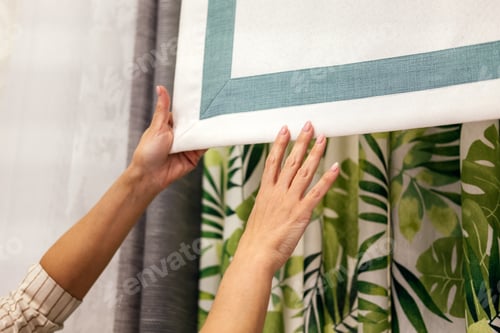 Preview: Female hands choosing fabric for curtain indoor