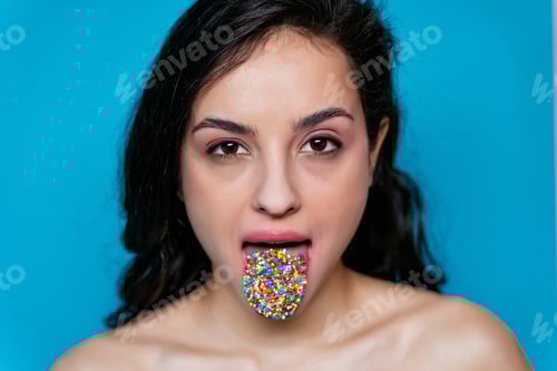 Preview: Artistic image of a female mouth with colored sprinkles on her tongue