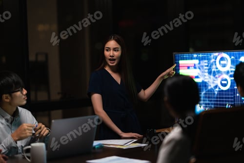 Preview: Asia businessmen and businesswomen meeting brainstorming ideas in small modern night office.