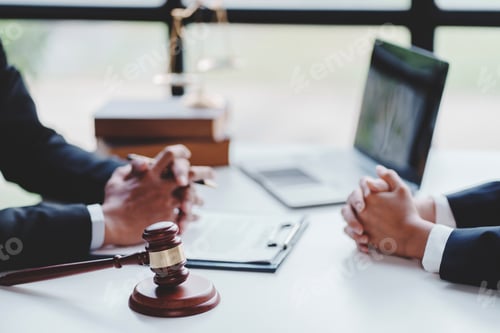 Preview: concept of justice and law A male judge in the courtroom on a wooden table and a male counselor or l