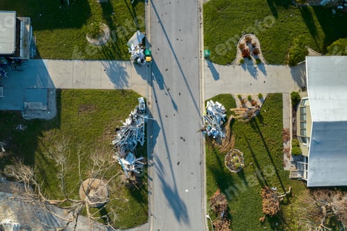 Preview: Heaps of debris rubbish on street side near severely damaged by hurricane