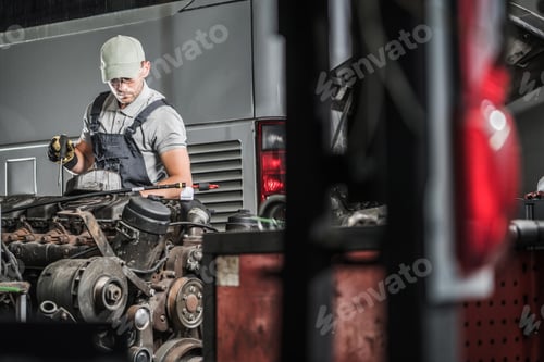 Preview: Man Repairing Truck Engine in Auto Garage