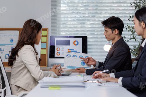 Preview: Business team analyzing financial data in meeting