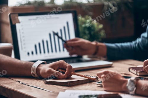 Preview: Close up of modern people analyzing data using laptop while working in the office