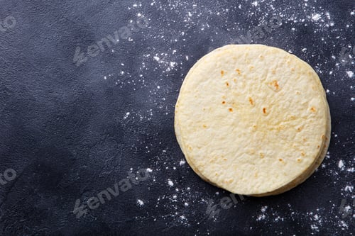 Preview: Tortillas, flat breads on dark grey background. Copy space. Top view