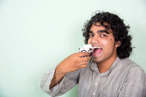 Preview: Young man eating the cake