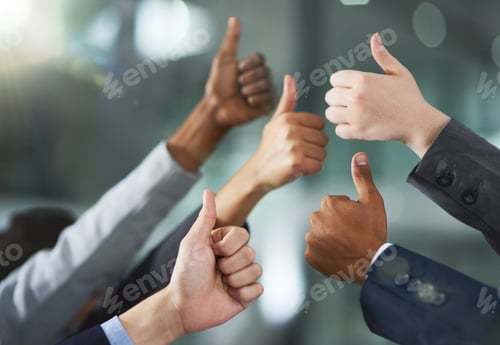 Preview: You did it. Shot of a group of office workers giving thumbs up together.