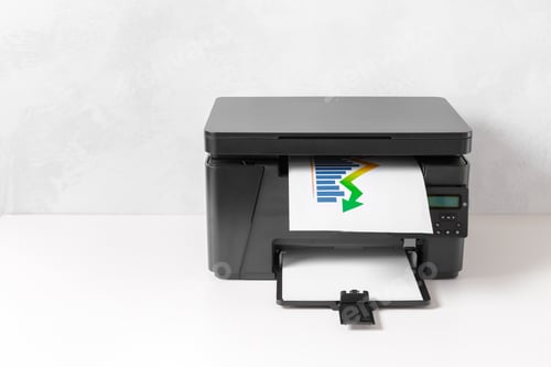 Preview: Printer is printing a colorful document on a plain desk in an office setting during the day