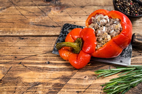 Preview: Roasted sweet bell pepper with meat, rice and vegetables. wooden background. Top view. Copy space