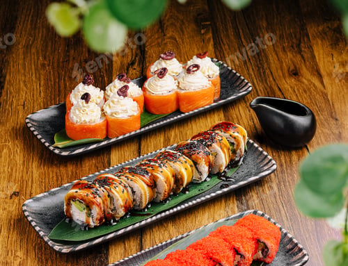 Preview: Artfully arranged sushi rolls on wooden table in Japanese restaurant setting