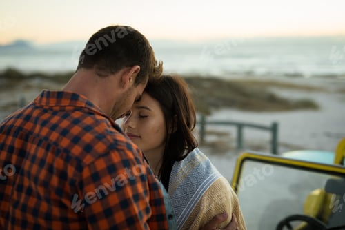 Preview: Happy caucasian couple on the beach touching foreheads