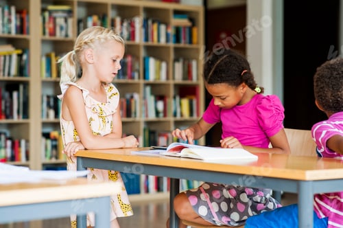 Preview: Children engaged in reading at a library table.