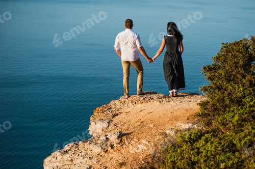 Preview: Couple in love at dawn by the sea. Honeymoon trip. Man and woman traveling