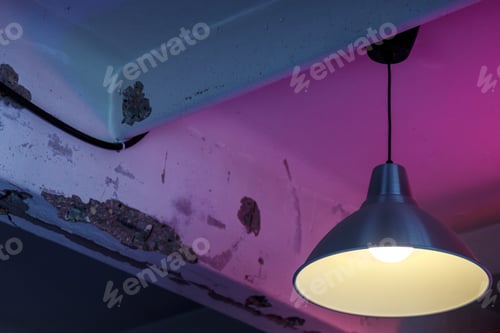 Preview: Lamp in shade on old ceiling. Lighting device on an old textural background