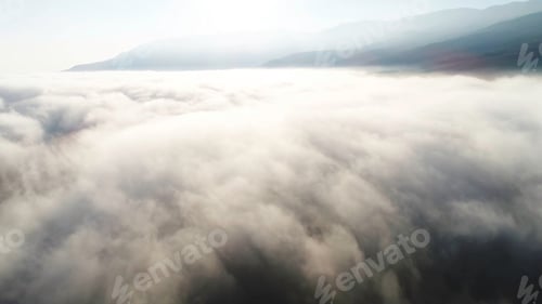 Preview: Aerial view of clouds and landscape under them. Shot. Top view of the clouds under the sky. Under