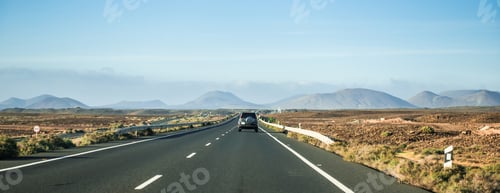 Preview: car driving away to mountains in Canary Island desert