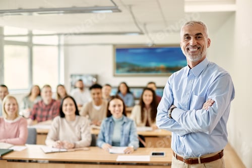 Preview: Portrait of happy mature teacher with crossed arms at university classroom.