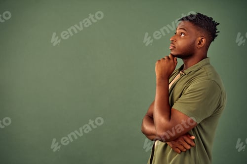 Preview: Lost in thoughts. Side view of handsome african american young man with pensive facial expression ho