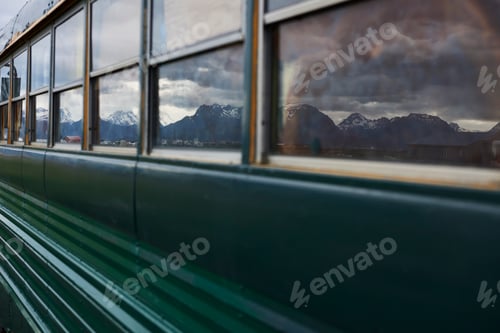 Preview: Reflection of mountain ranges on windows of mobile home bus, Homer, Alaska, United States